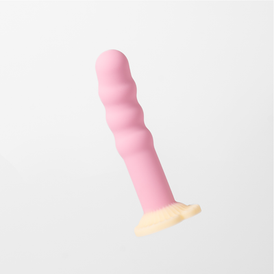 Dilly, Pink ribbed silicone dildo with a cream coloured suction heart-shaped base, shown against a white background.