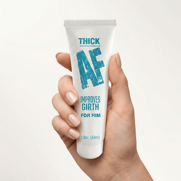 Hand holding a white Thick AF Girth Enhancing Cream tube with teal lettering reading Improves Girth For Him