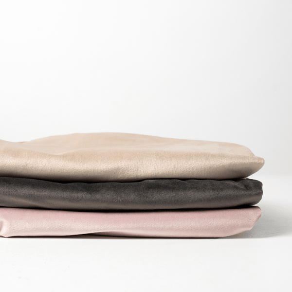Soft and stylish Bumpy Cuddles spare pillow cases in beige, black, and pink stacked neatly.