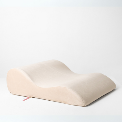 Side view of Bumpy Cuddles intimacy pillow in beige by Girls Get Off – ergonomic support cushion designed to elevate comfort and alignment during intimacy.
