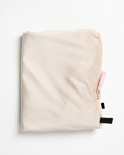 Beige sex pillow cover with black loops and a pink Girls Get Off zipper tag
