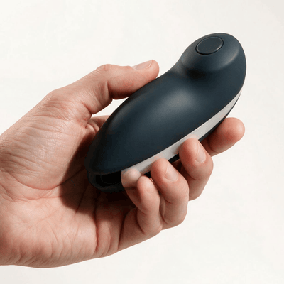Teal and blue packaging box for the Satisfyer Secret Affair vibrator against a plain background.