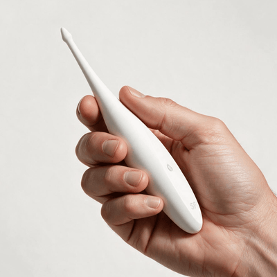 Satisfyer Twirling Fun Tip Vibrator White held in a hand, slim pointed tip visible